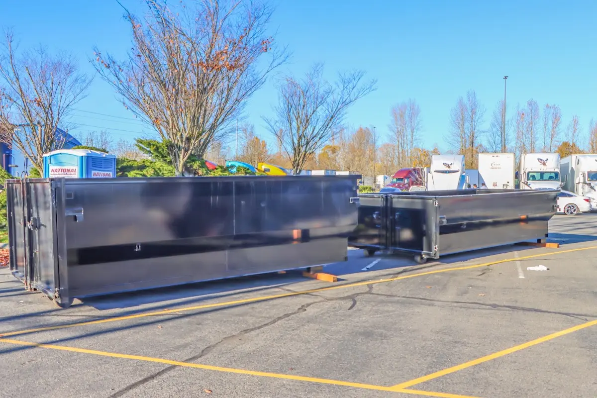 Professional dumpster rental service with roll-off container on residential driveway in Mustang